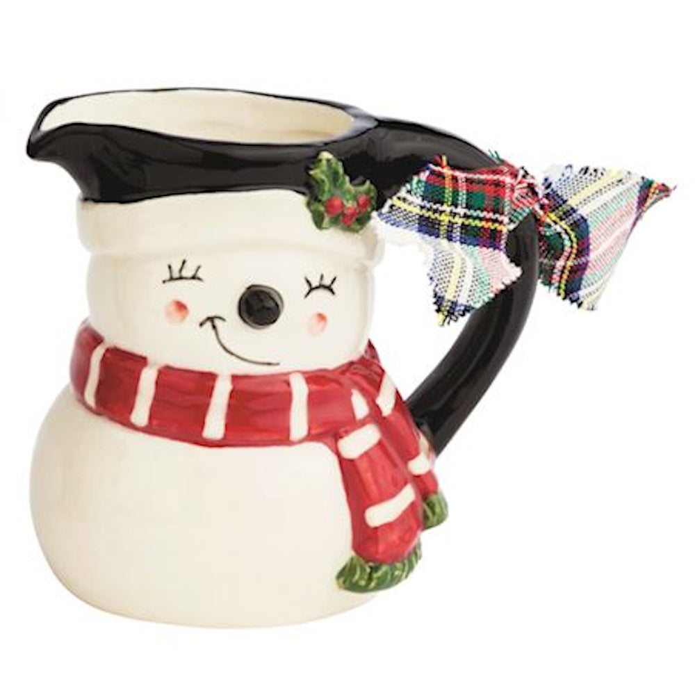 Ceramic snowman-shaped mini pitcher or vase wearing a red scarf and a plaid bow on the handle.