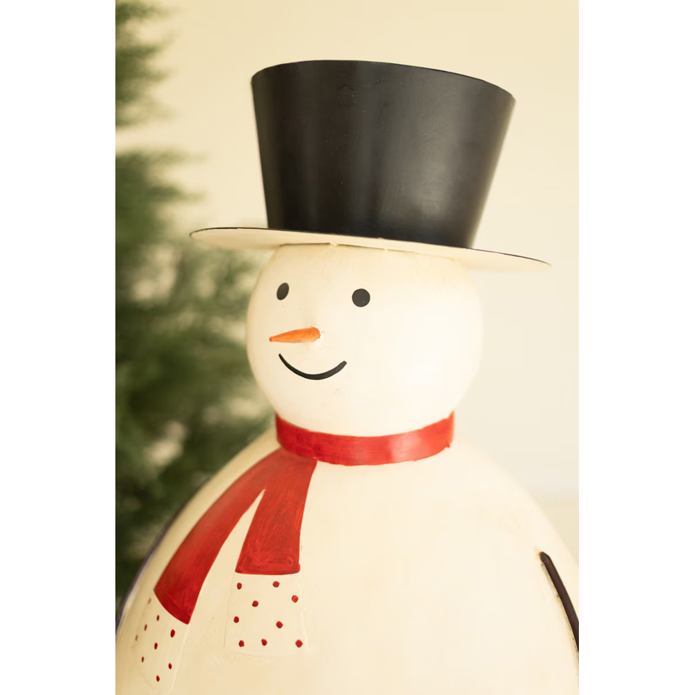Close-up view of a painted metal snowman sculpture featuring a black top hat and red scarf.