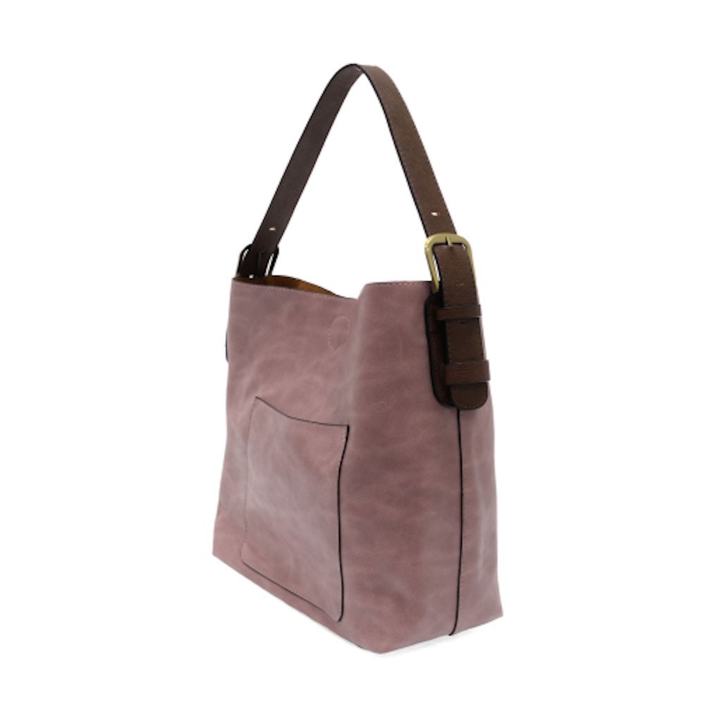 Dusty rose hobo shoulder bag with a brown leather strap and gold buckle detail against a white background.