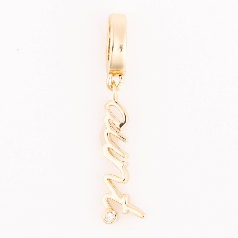 Gold pendant charm featuring the word "Aunt" in cursive script with a small crystal detail.