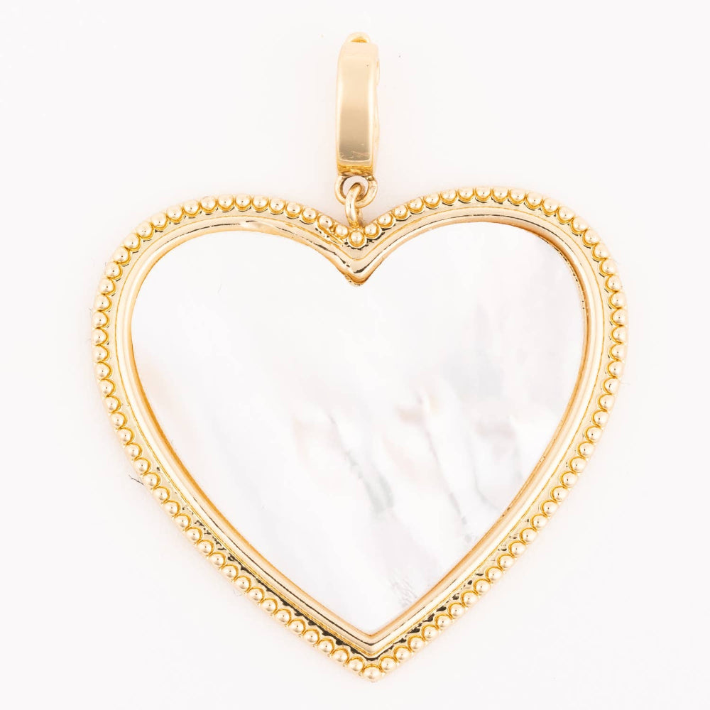 A gold heart-shaped pendant charm with a mother-of-pearl inlay on a plain white background.