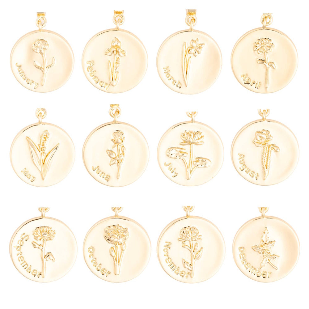 Collection of twelve round gold pendant charms, each featuring an engraved birth flower and month name.