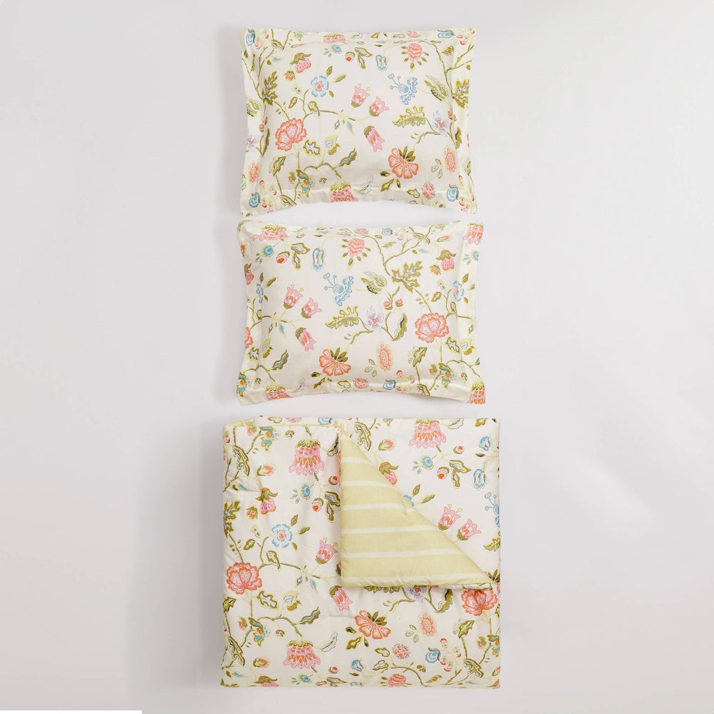 Floral bedding set with two pillow shams and a matching reversible comforter featuring a striped underside.