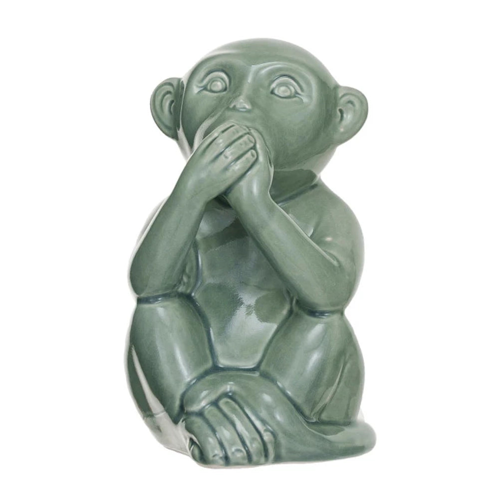 Green stoneware monkey figurine in a "speak no evil" pose with a glossy finish for home decor.