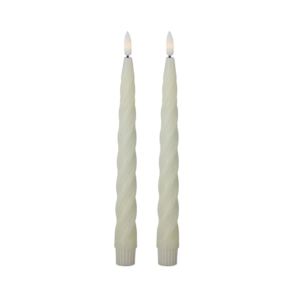 Two white spiral LED taper candles on a plain white background.