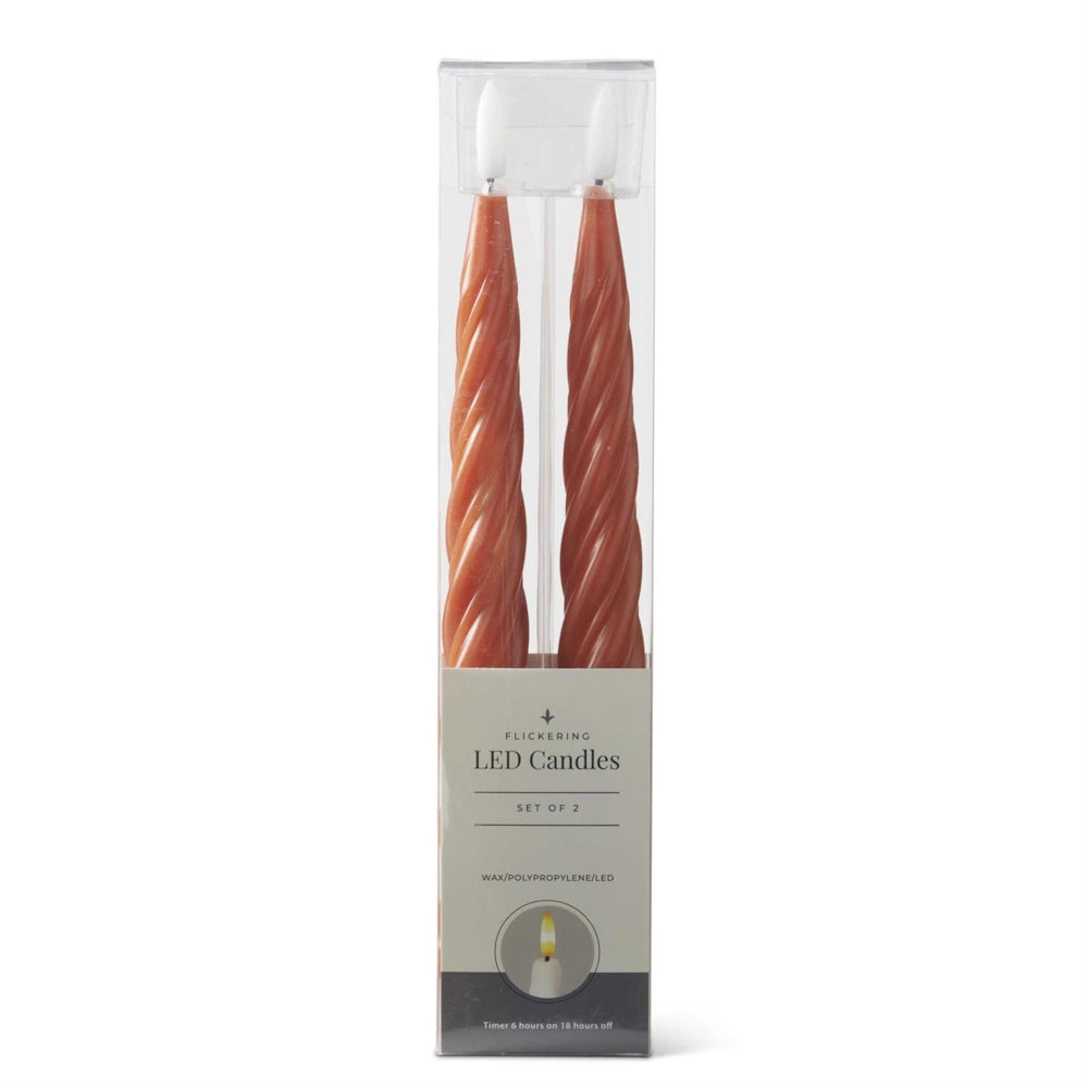 A set of two orange spiral LED taper candles in clear packaging with a "Flickering LED Candles" label.