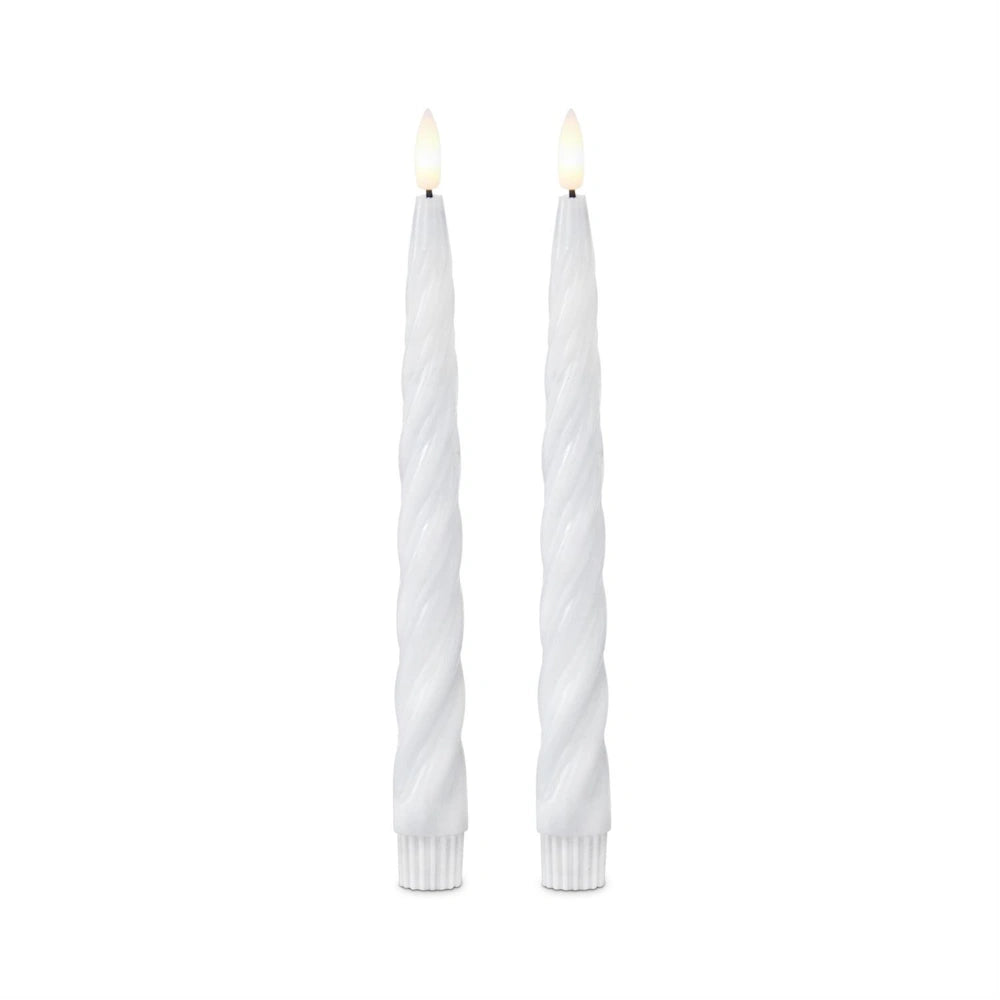 A pair of white spiral LED taper candles with glowing faux flames against a plain white background.