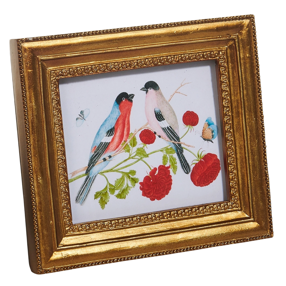 Two colorful birds perched on a flowering branch are set in an ornate gold frame. Bright red flowers and a butterfly accent the serene scene.