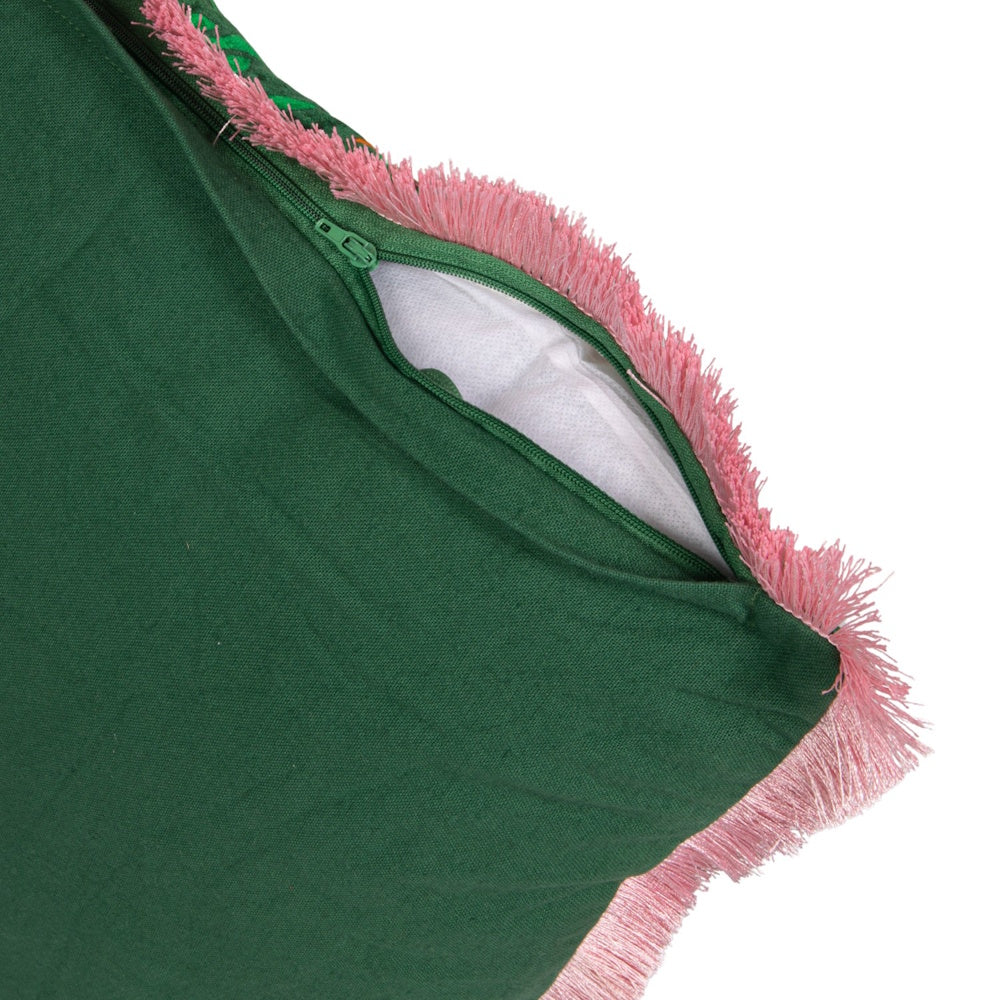 Green pillow cover with a pink fringe border, featuring a partially open green zipper showing white stuffing.