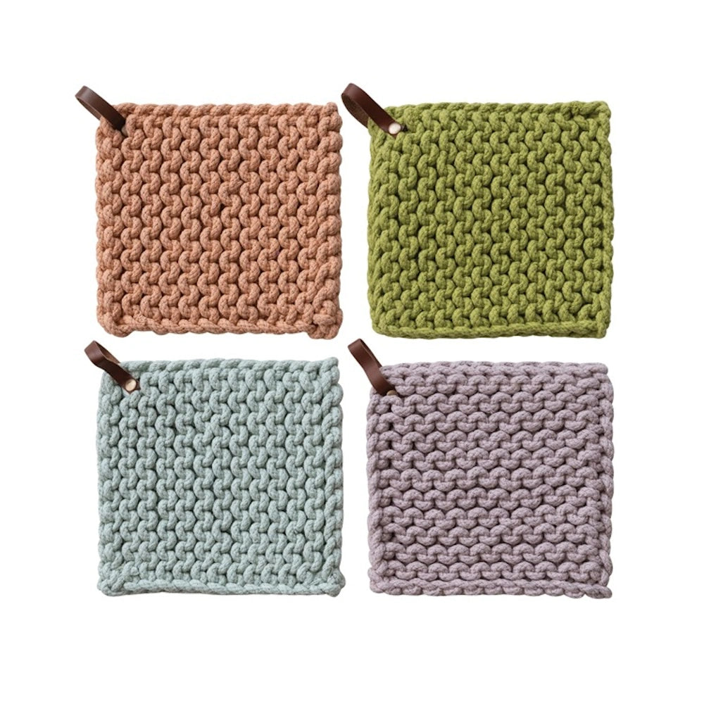 Four square chunky cotton crocheted pot holders in earth tones with leather hanging loops on a white background.
