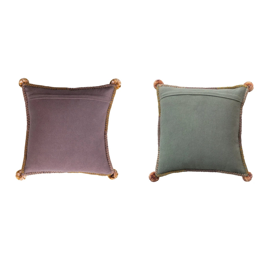 Set of two square decorative throw pillows in mauve and sage green with corner tassels and embroidered trim.