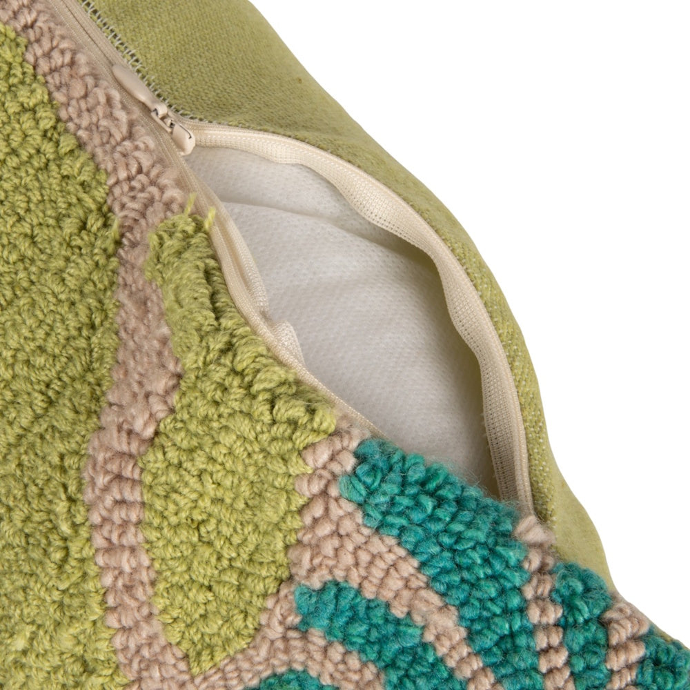 Hidden zipper closure on a tufted green and beige indoor-outdoor decorative pillow with floral embroidery.