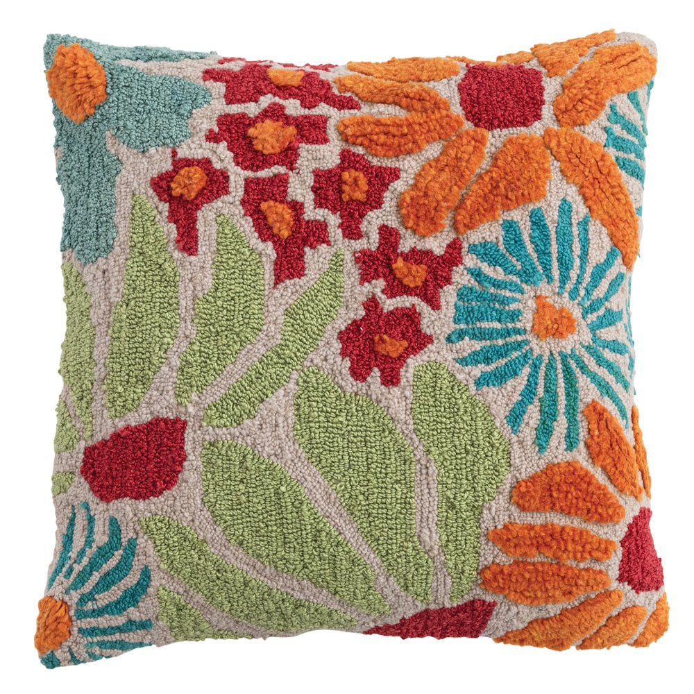 Square tufted indoor-outdoor pillow with colorful hooked floral patterns in orange, red, and blue on a beige background.