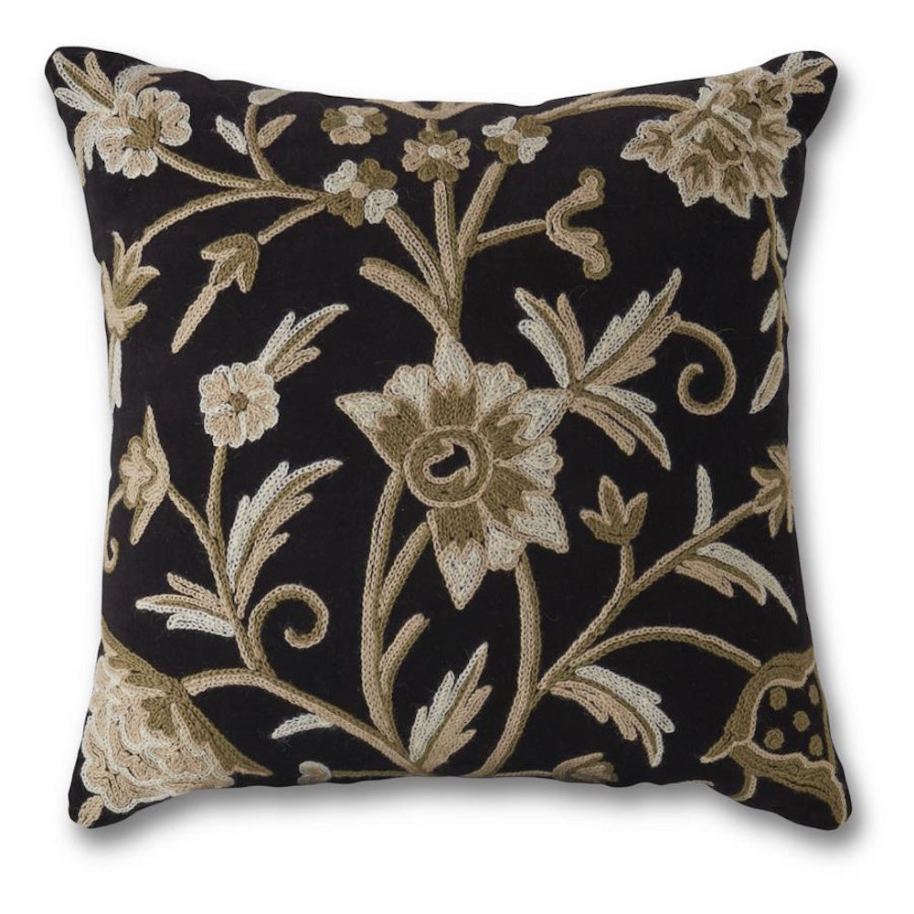 Black square throw pillow with hand-embroidered cream and gray floral patterns on a dark fabric background.