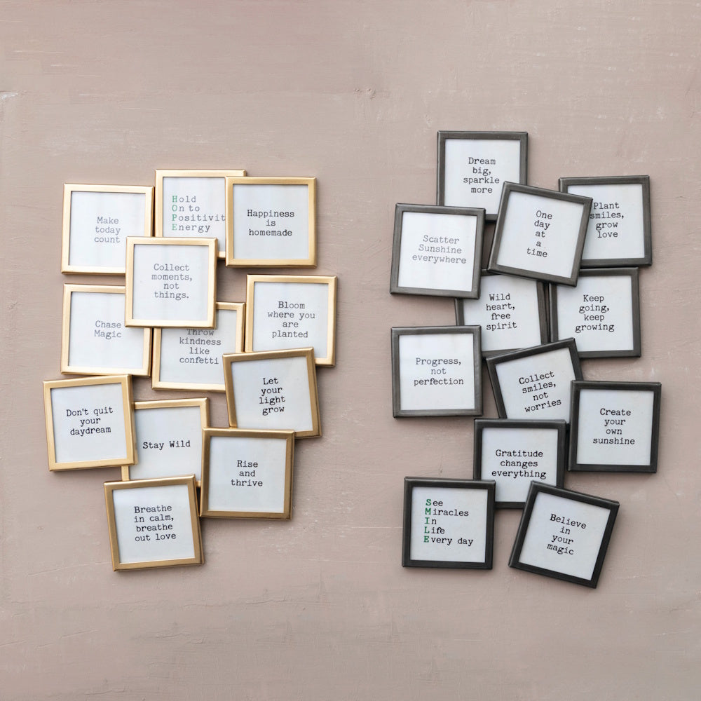 Two groupings of square metal-framed magnets with various motivational sayings arranged on a wall.