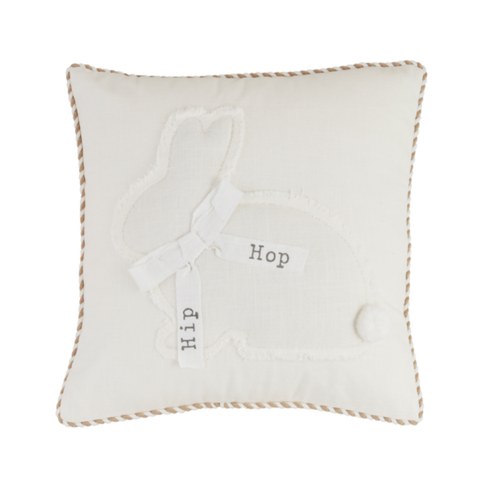 White pillow with a frayed bunny applique, a pom-pom tail, and a bow that reads "Hip Hop".