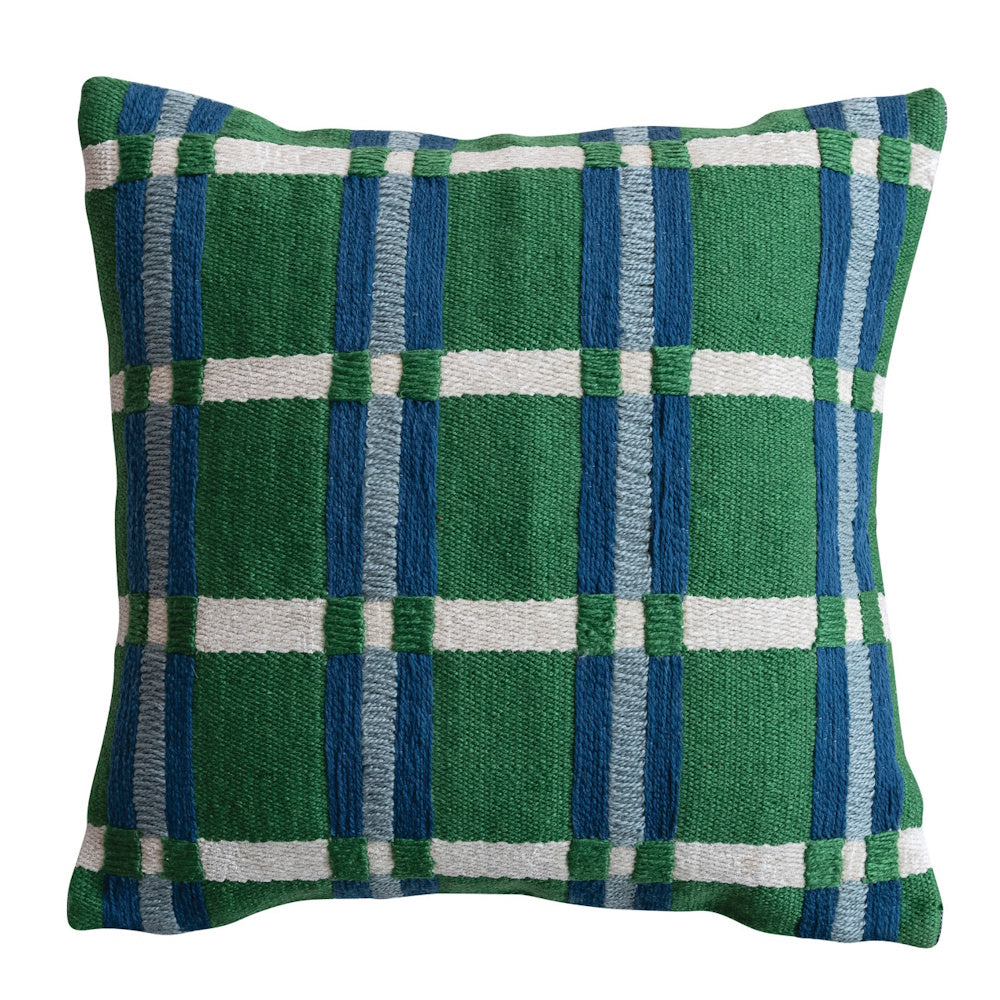 Green and blue plaid embroidered square pillow on woven fabric, ideal for indoor or outdoor home decor.