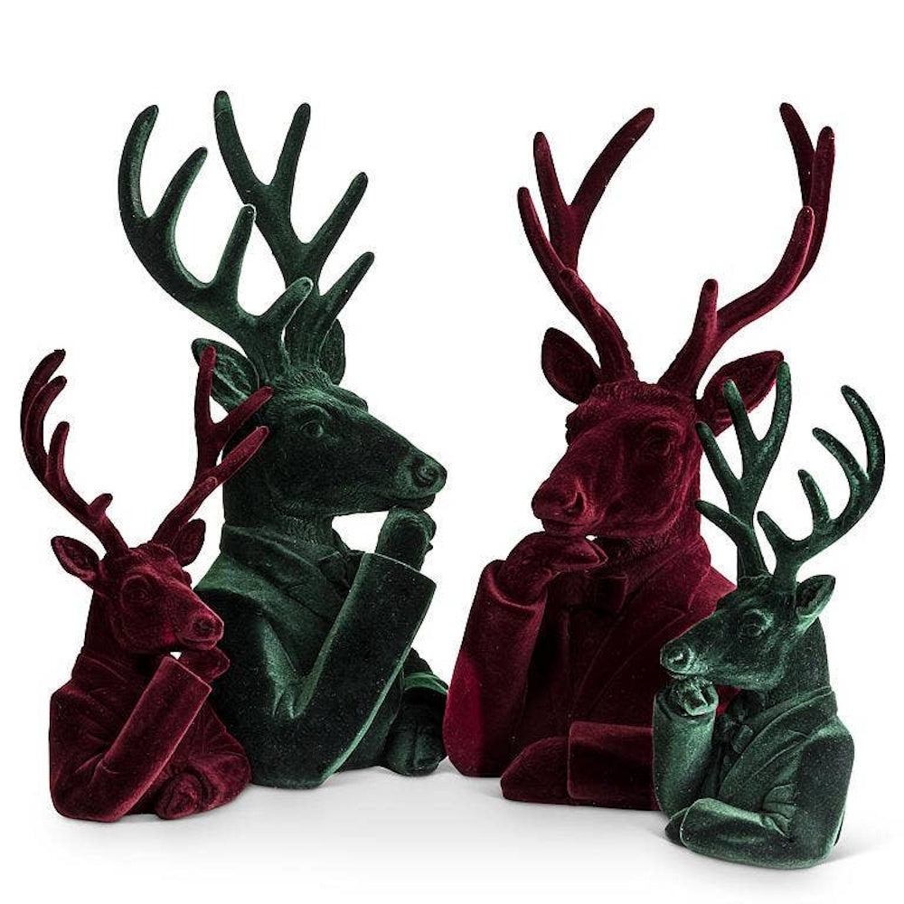 Four velvet stag busts in red and green suits, resting hand to chin in thought on white background.
