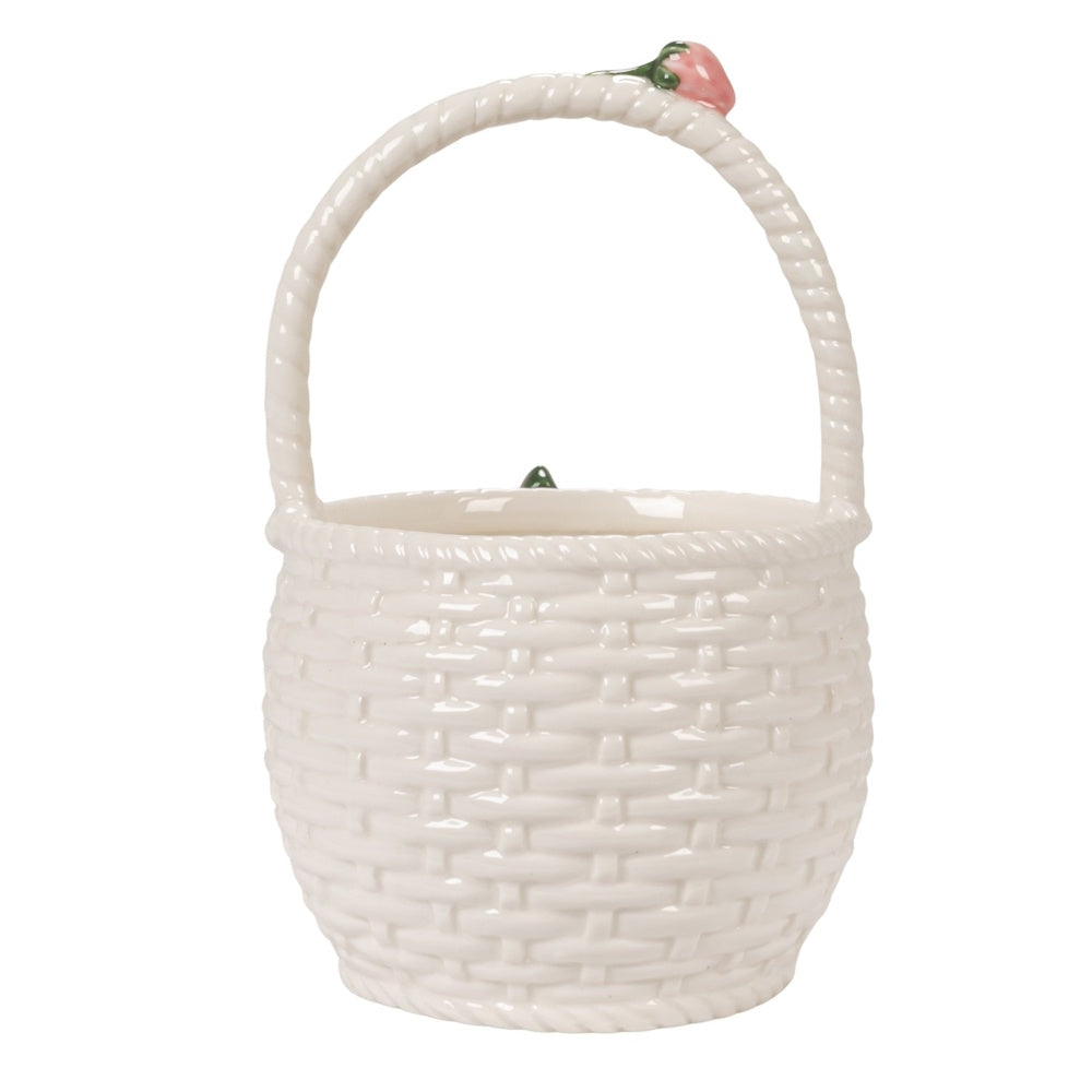 White ceramic basket-shaped stoneware container with woven texture and a strawberry accent on the curved handle.