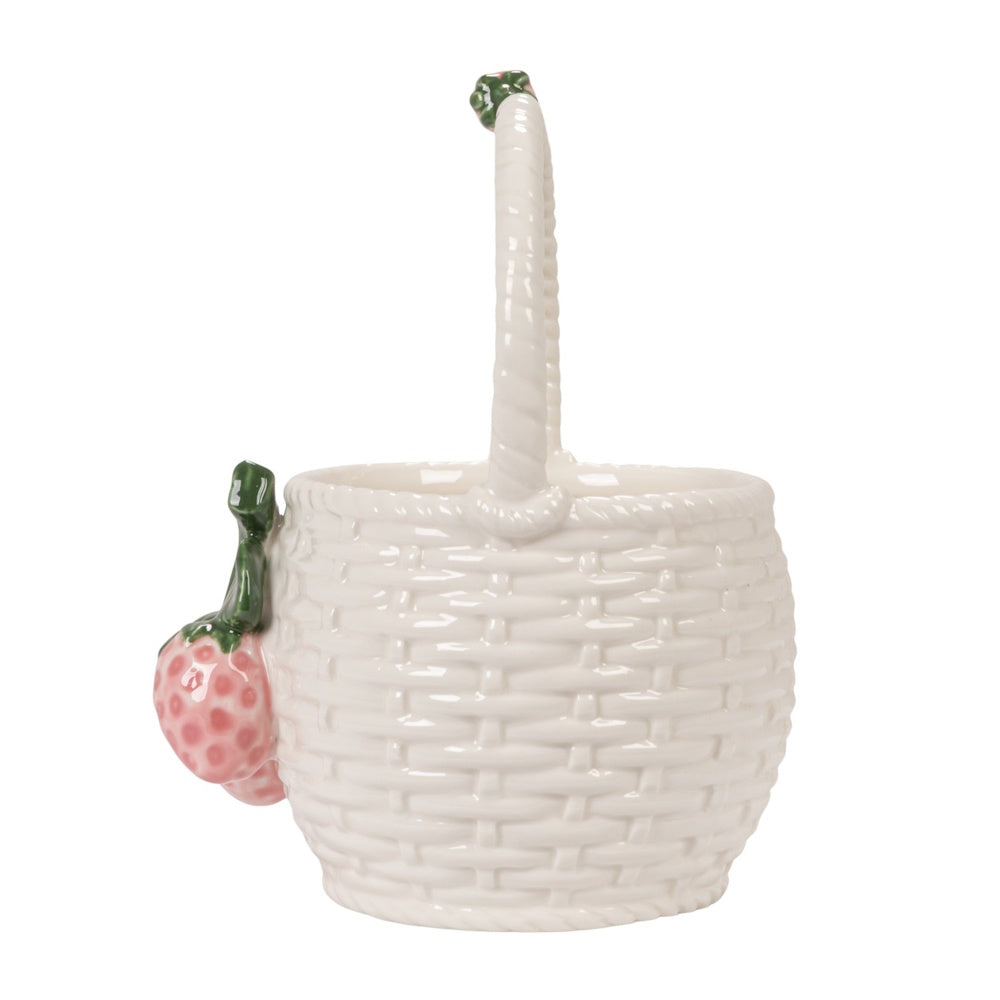 Side view of a white ceramic basket-shaped container with woven texture and 3D strawberry accents on a white background.
