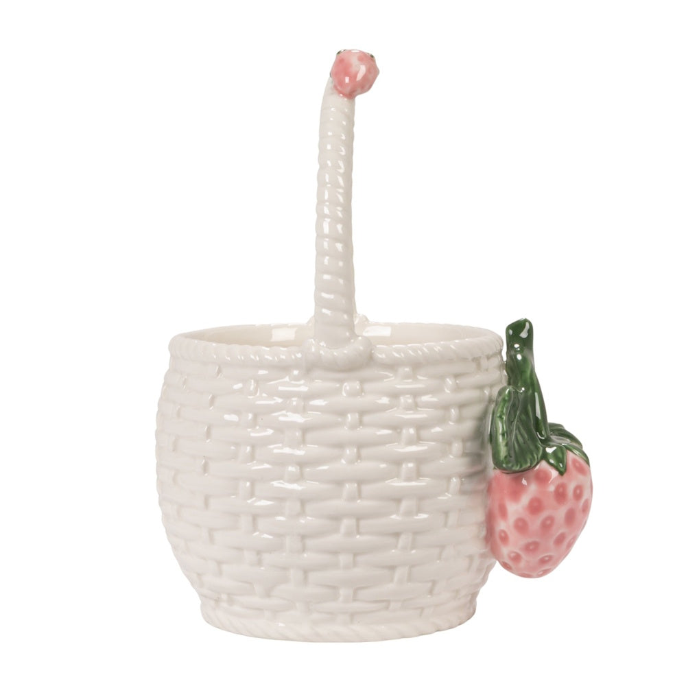 Side view of a white ceramic basket-shaped container with a woven pattern and 3D strawberry accents on the side and handle.