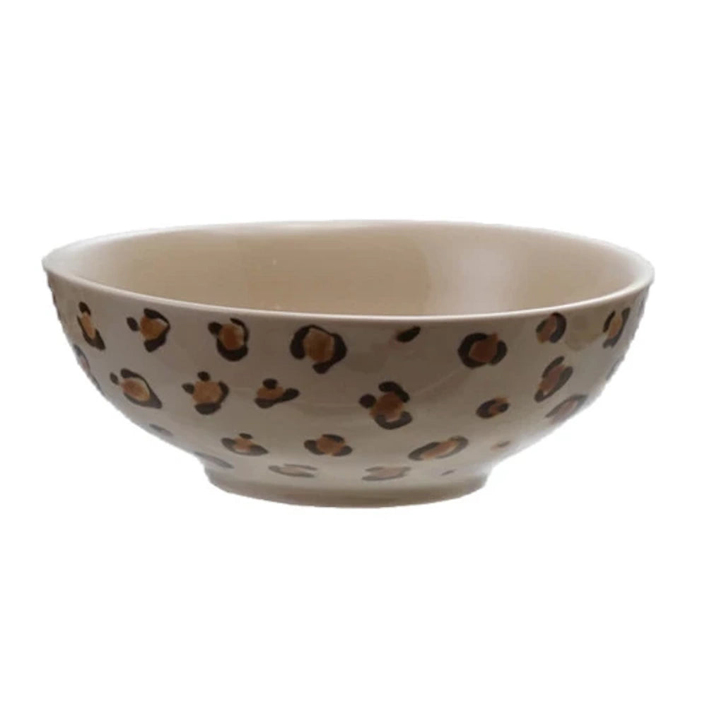 Leopard print ceramic cereal bowl with brown and black animal spots on a cream background.