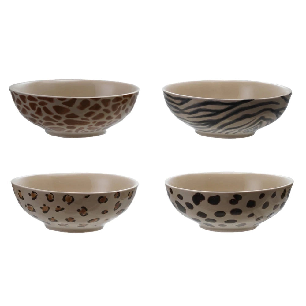 Animal print ceramic bowl set with safari patterns including zebra stripes and leopard spots for home dining.