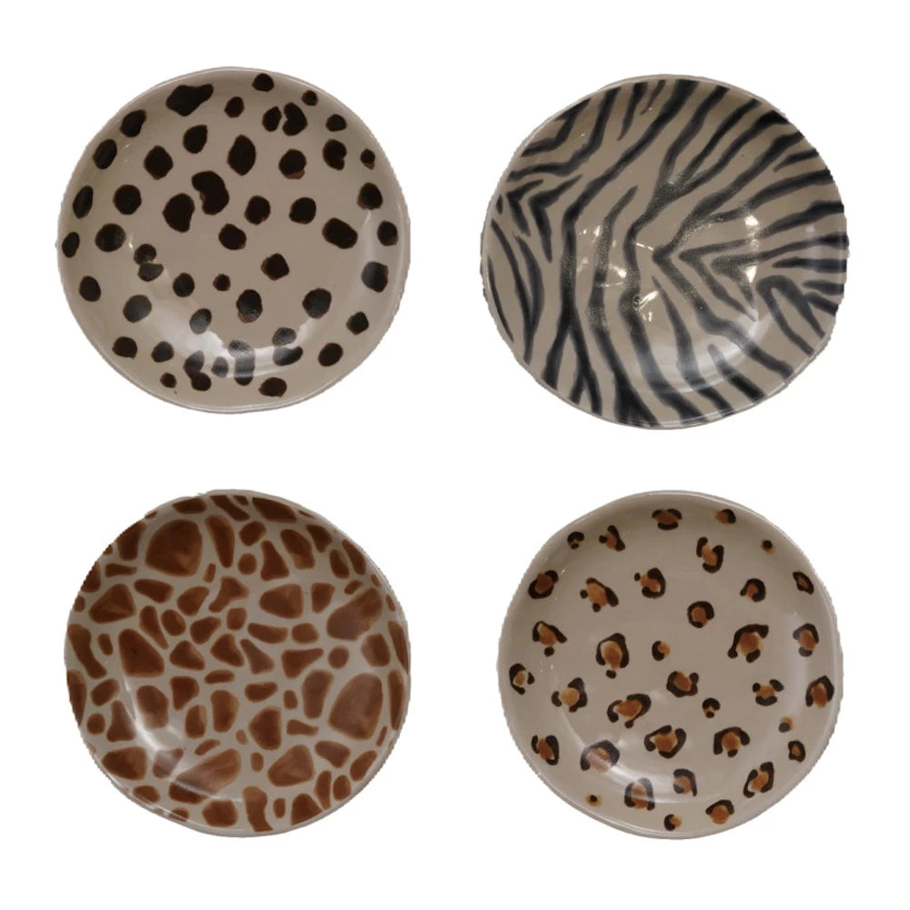 Set of 4 ceramic animal print plates featuring dalmatian, zebra, giraffe, and leopard patterns on a white background.