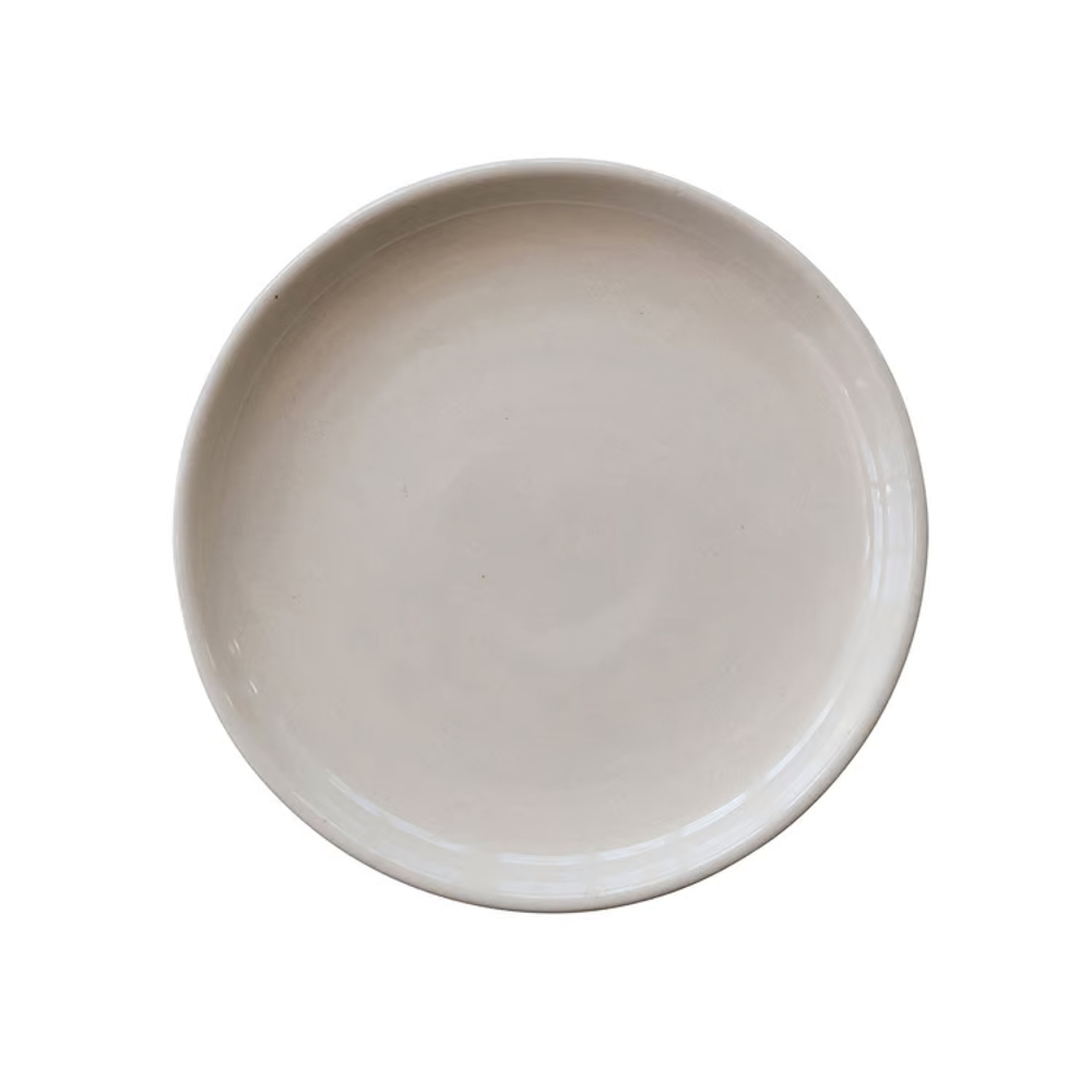 Top-down view of a smooth, light beige round stoneware plate with raised edges on a plain white background.
