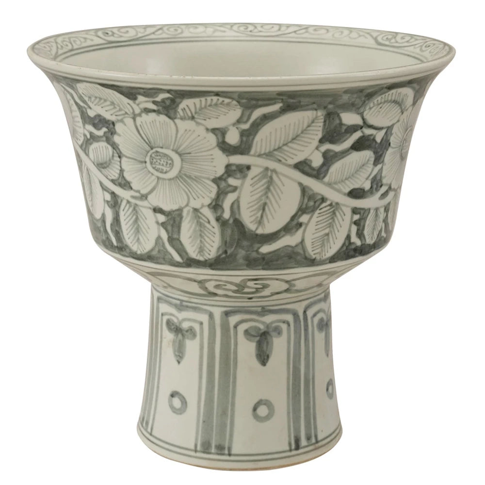 A ceramic footed planter with a grey and white floral vine design and a tapered pedestal base on a white background.