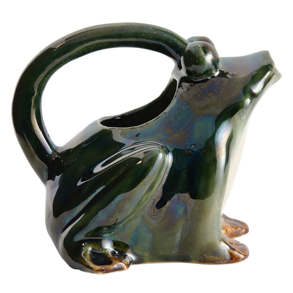 Side-angle view of a glossy, dark green ceramic frog watering pitcher with an iridescent finish and large handle.