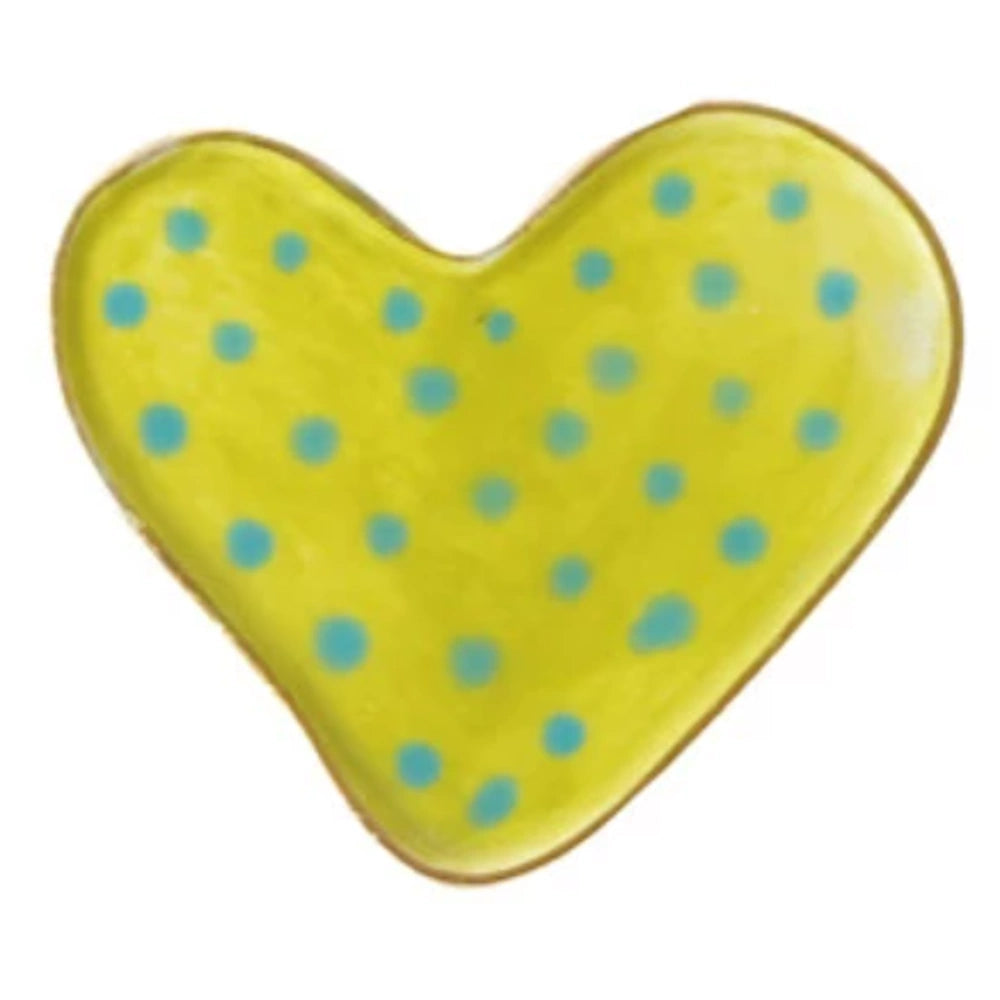Yellow stoneware heart-shaped magnet with a bright lime green glaze and blue polka dot pattern on a white background.