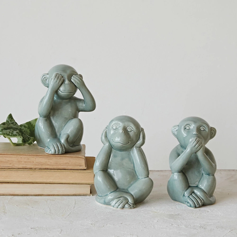 Three wise monkeys stoneware figurines in sage green, depicting see no evil, hear no evil, and speak no evil.