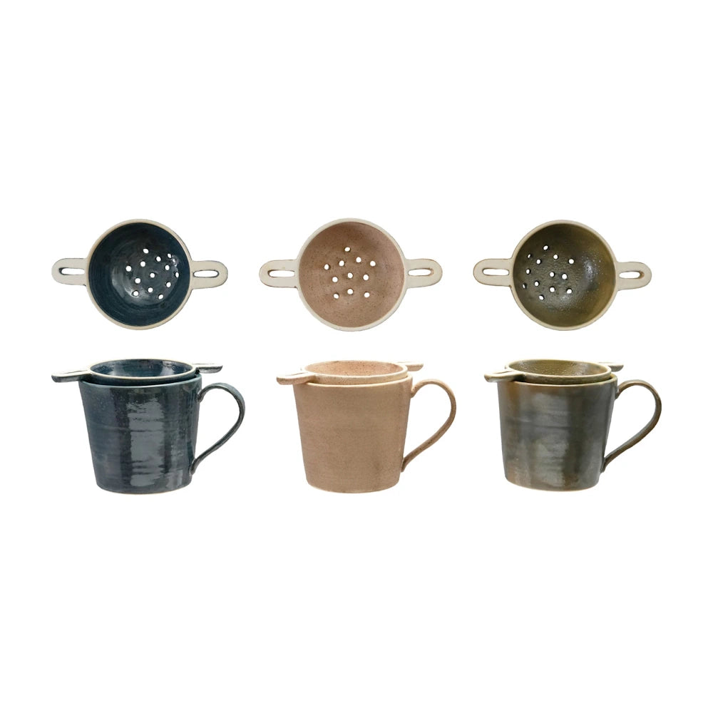 Handmade stoneware mugs and matching ceramic tea strainers in blue, tan, and olive green.