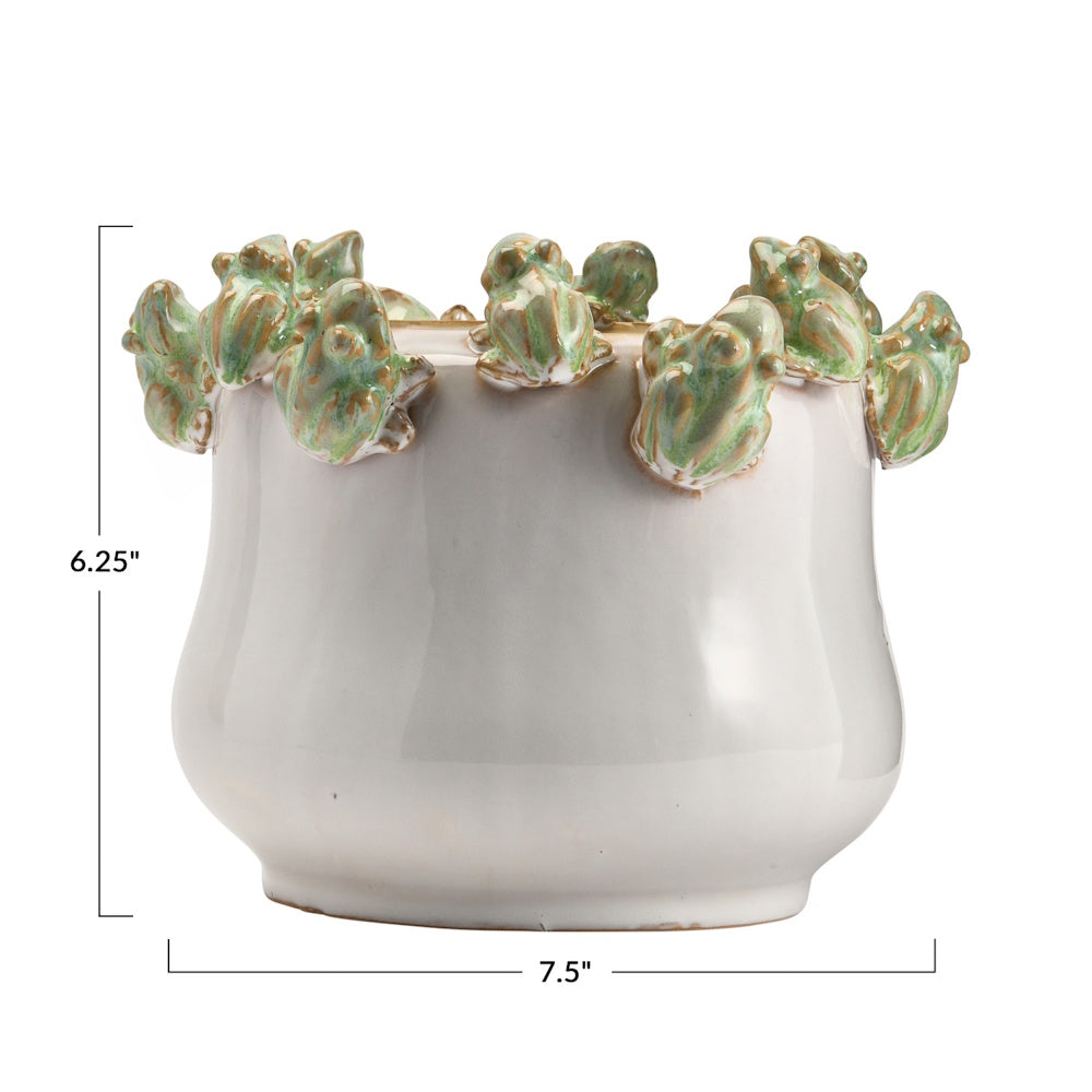 White stoneware planter with green frogs on the rim, measuring 6.25 inches high and 7.5 inches wide.