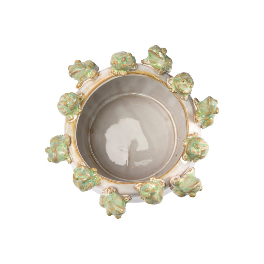 Top view of a round ceramic planter with a ring of small green and brown decorative frogs perched on the rim.