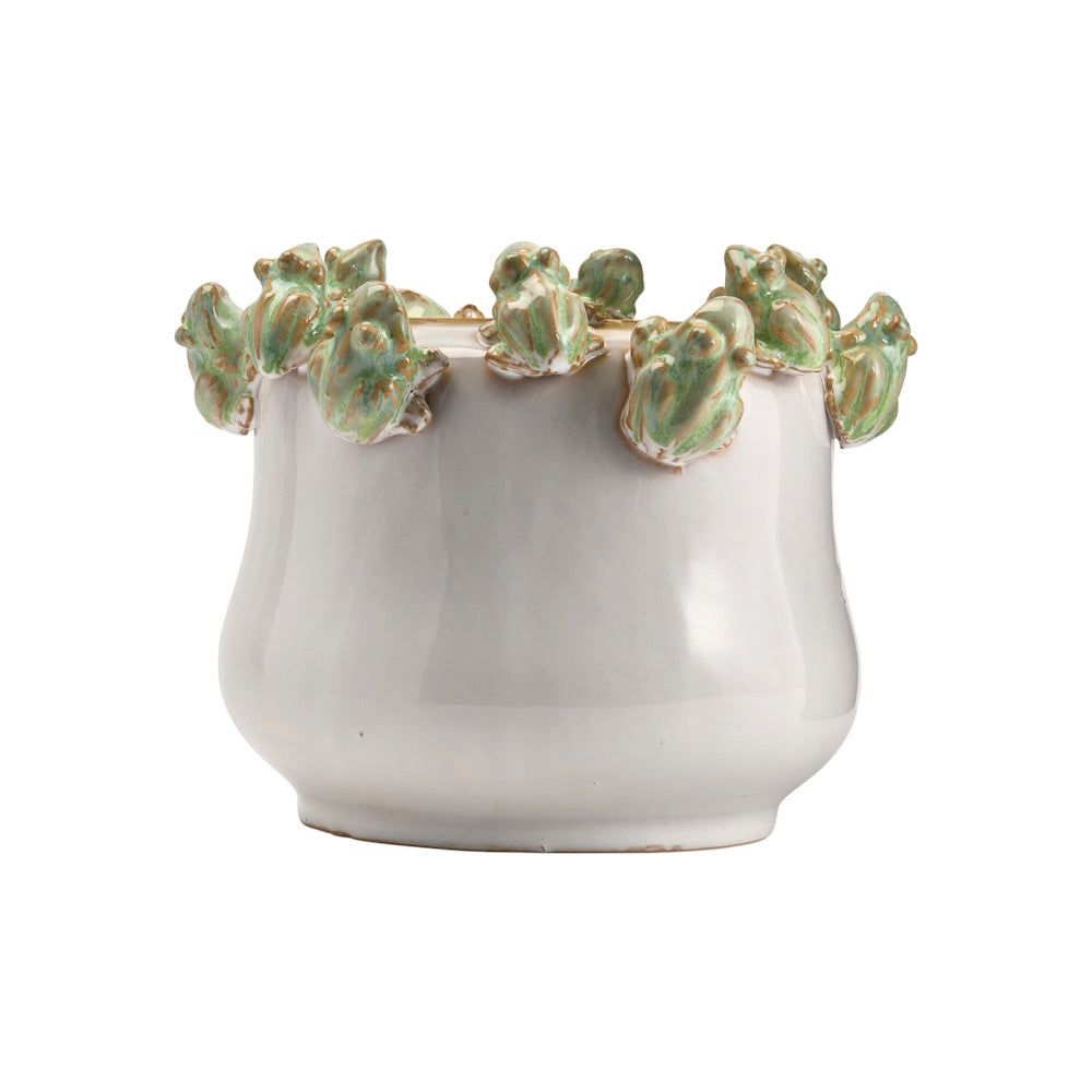 White ceramic planter with small green frogs sculpted around the rim.