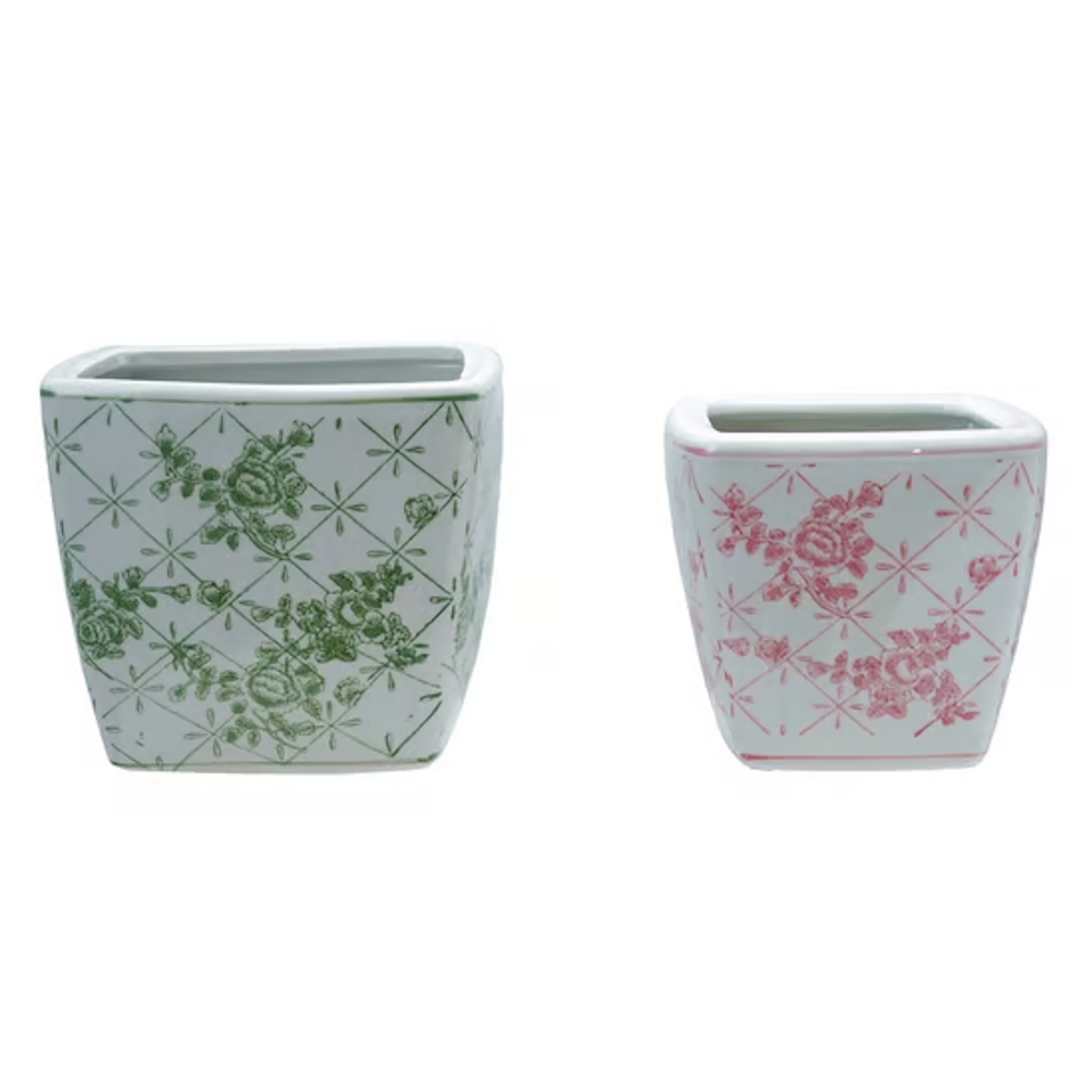 Pair of square white stoneware planters with green and pink floral trellis patterns.