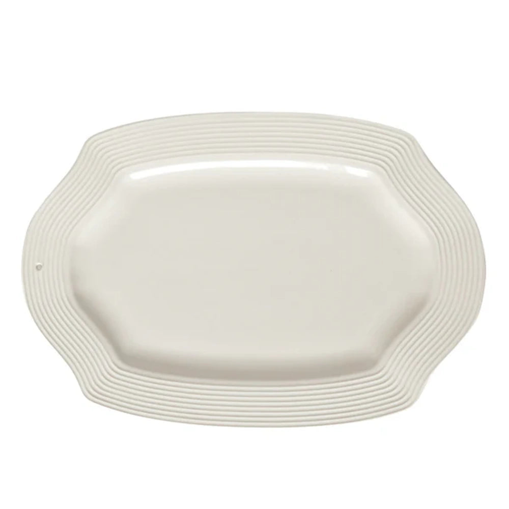 White oval stoneware platter with a ribbed decorative rim, ideal for serving food at dining events and parties.