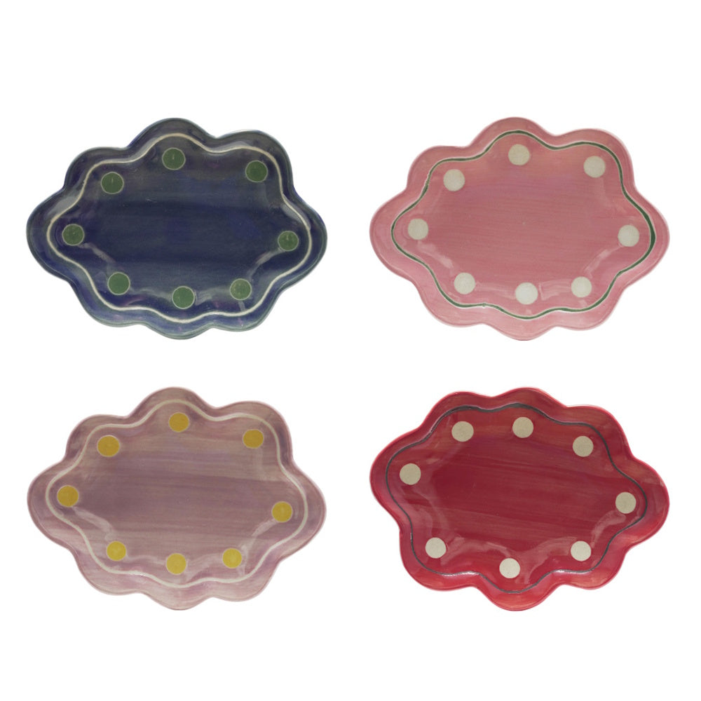 Four scalloped stoneware trinket dishes in blue, pink, lavender, and red, each with a decorative polka dot border.