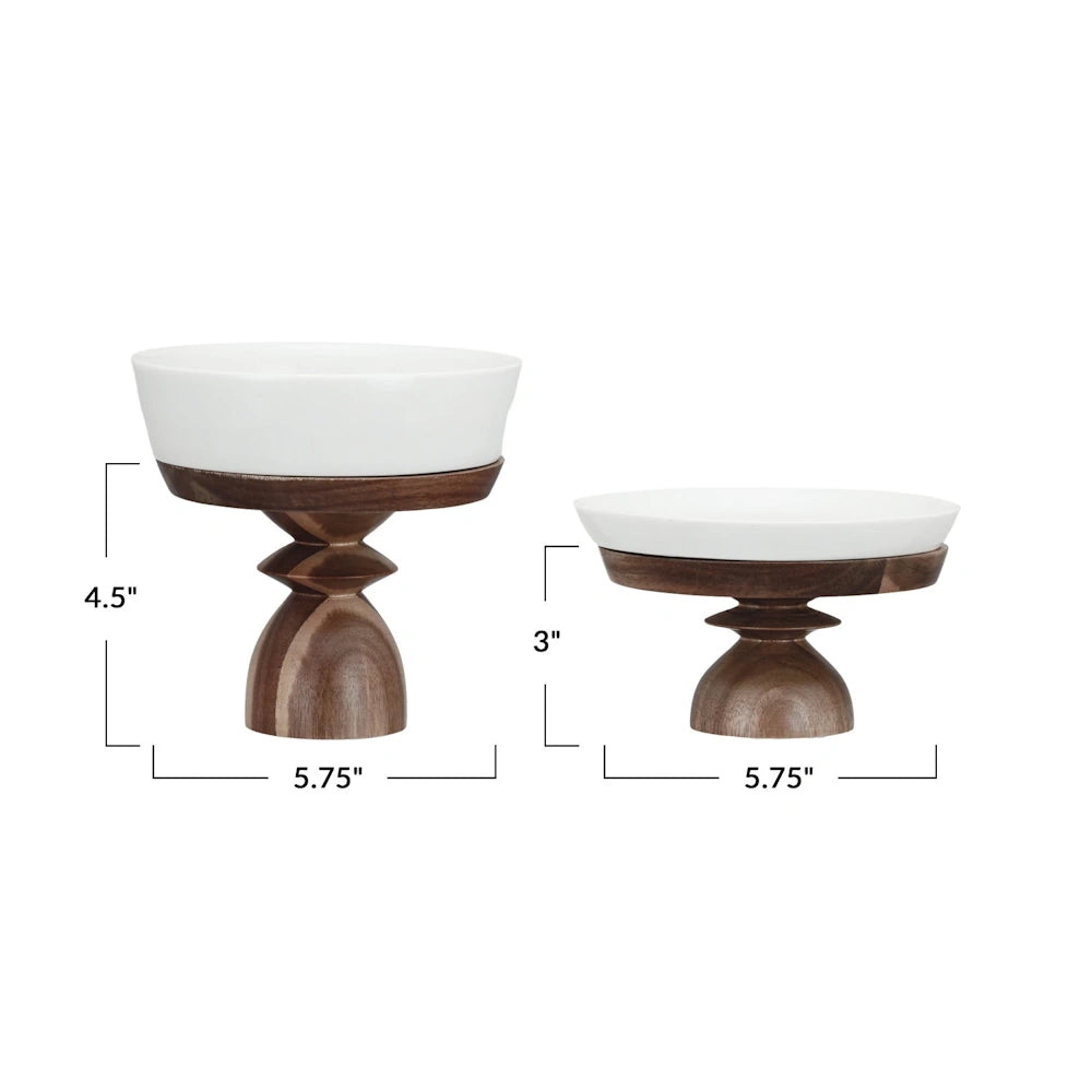 Stoneware serving dishes with acacia wood pedestals showing dimensions of 4.5 by 5.75 inches and 3 by 5.75 inches.