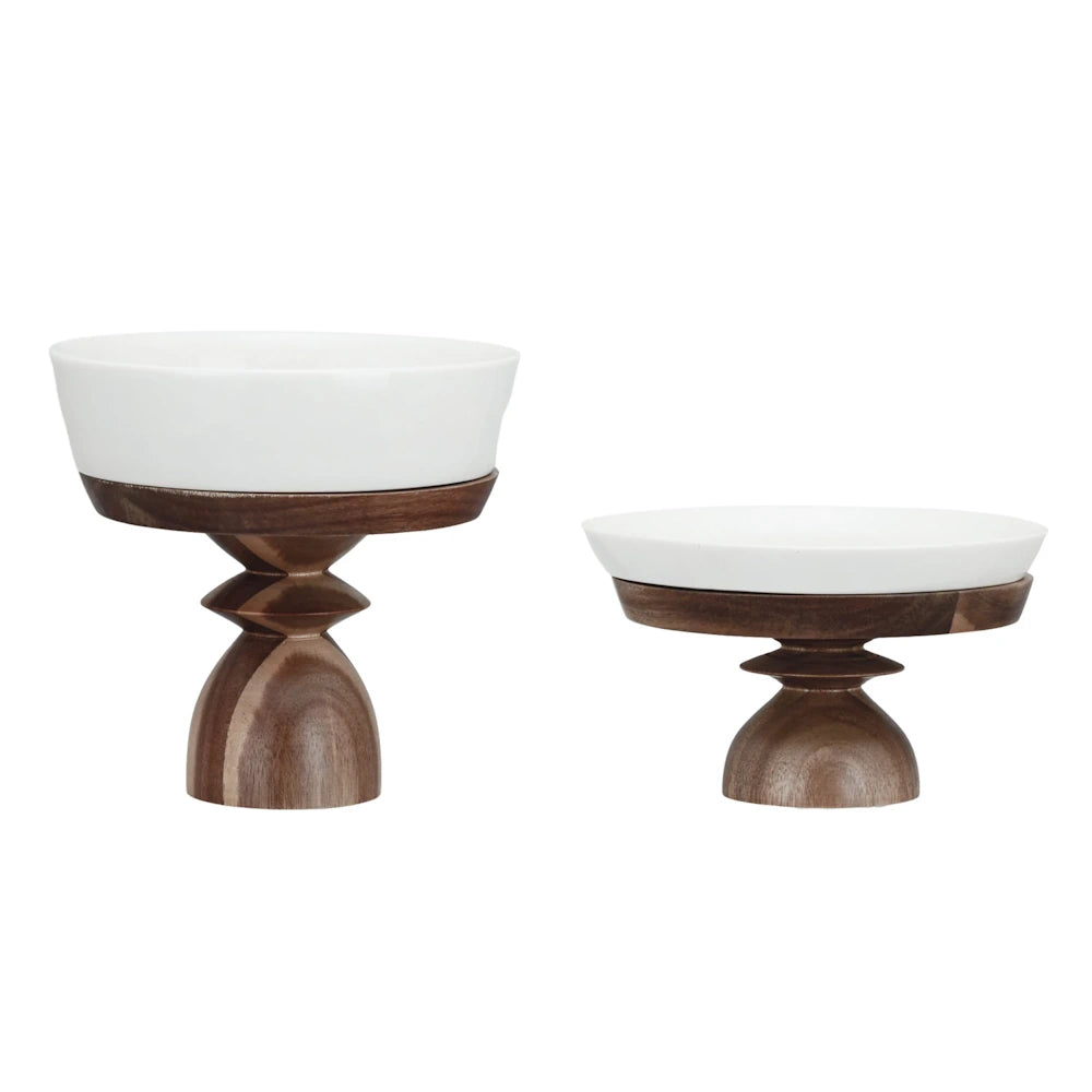 Stoneware serving dishes with acacia wood pedestals.