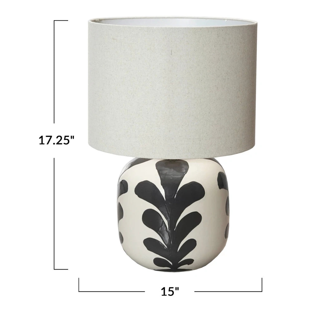 Stoneware table lamp with abstract black design and grey shade. Dimensions: 17.25" high by 15" wide.