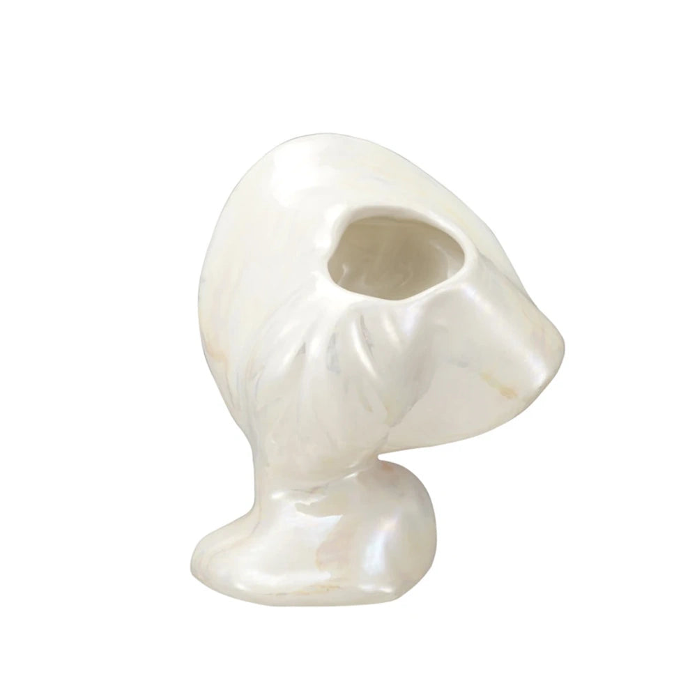 Rear view of a white ceramic vintage reproduction lady head vase showing the opening in the hat.