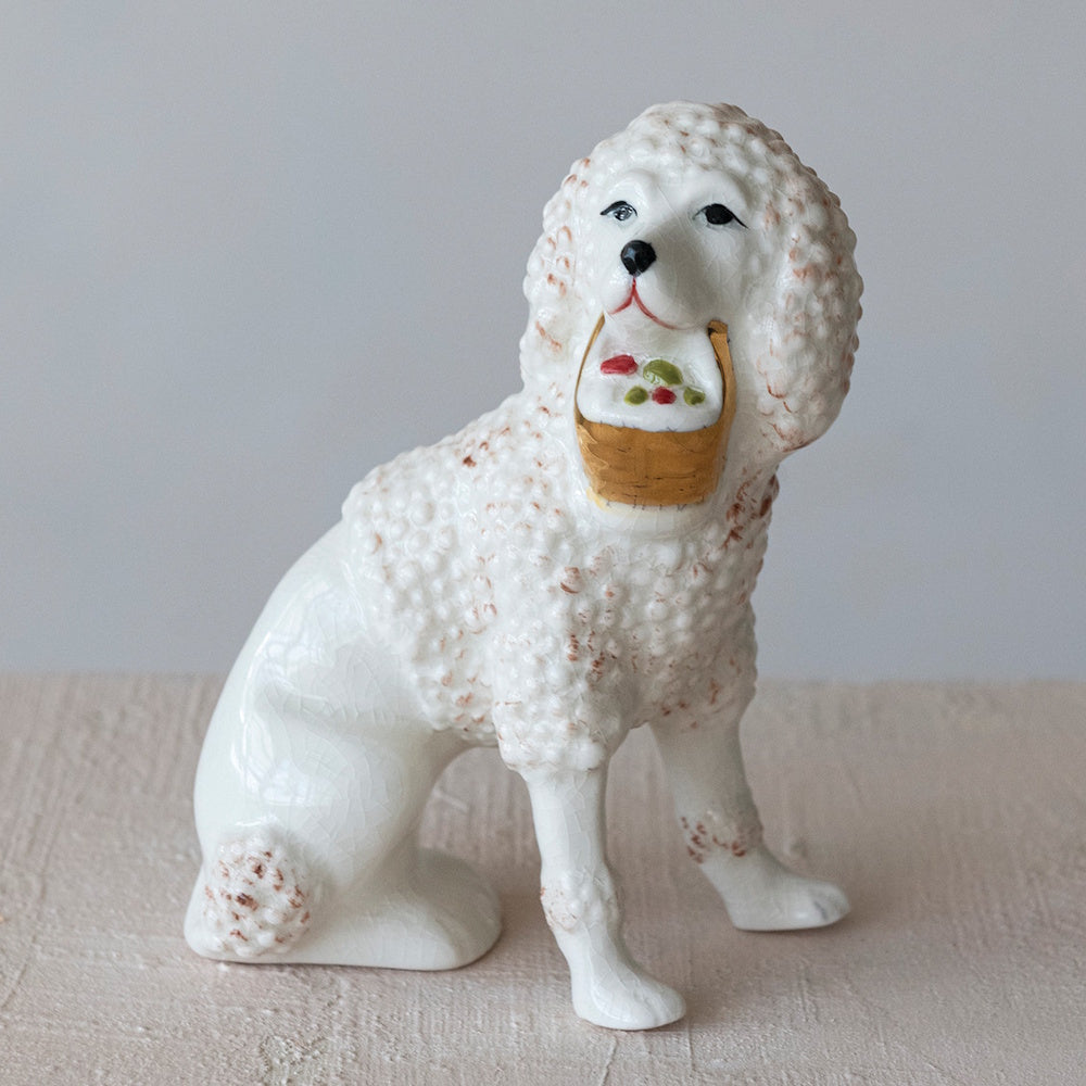 Vintage reproduction Staffordshire poodle stoneware figurine holding a flower basket.