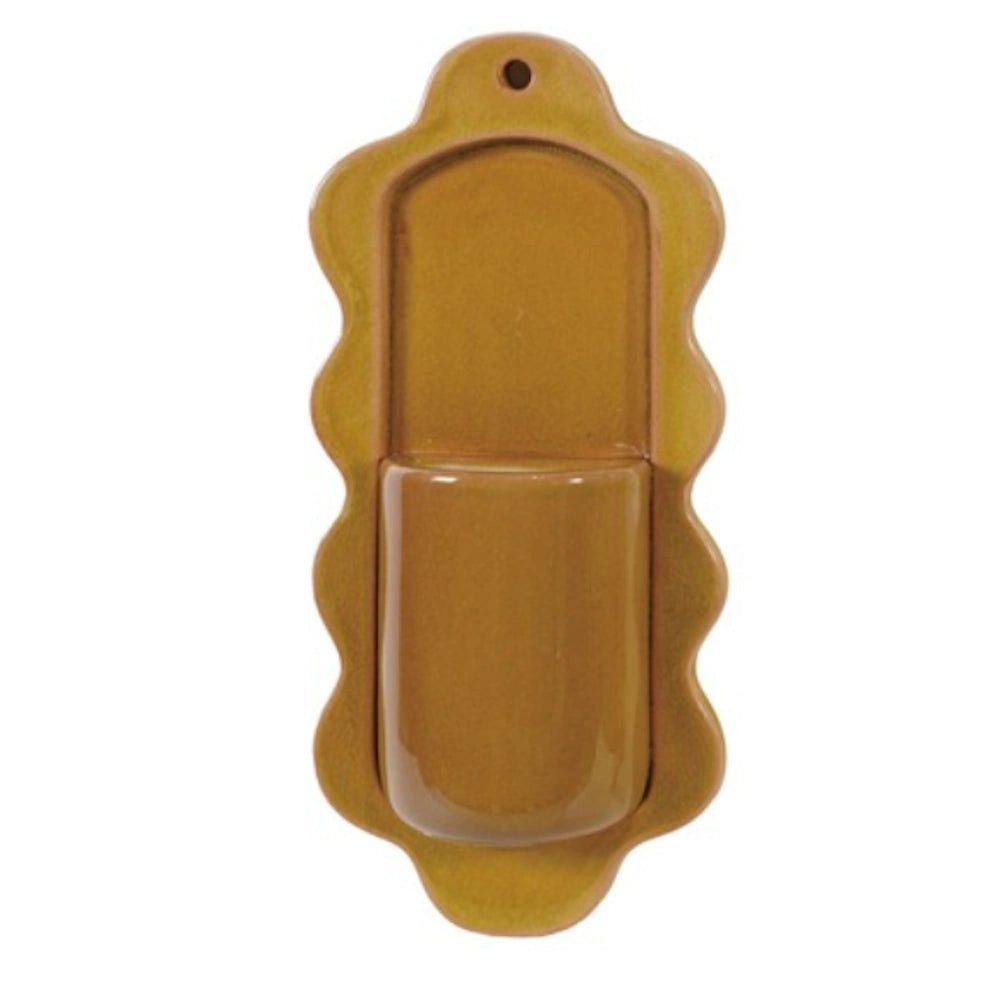 Yellow ochre stoneware wall vase with a scalloped edge and a small top hole for hanging, displayed on a white background.