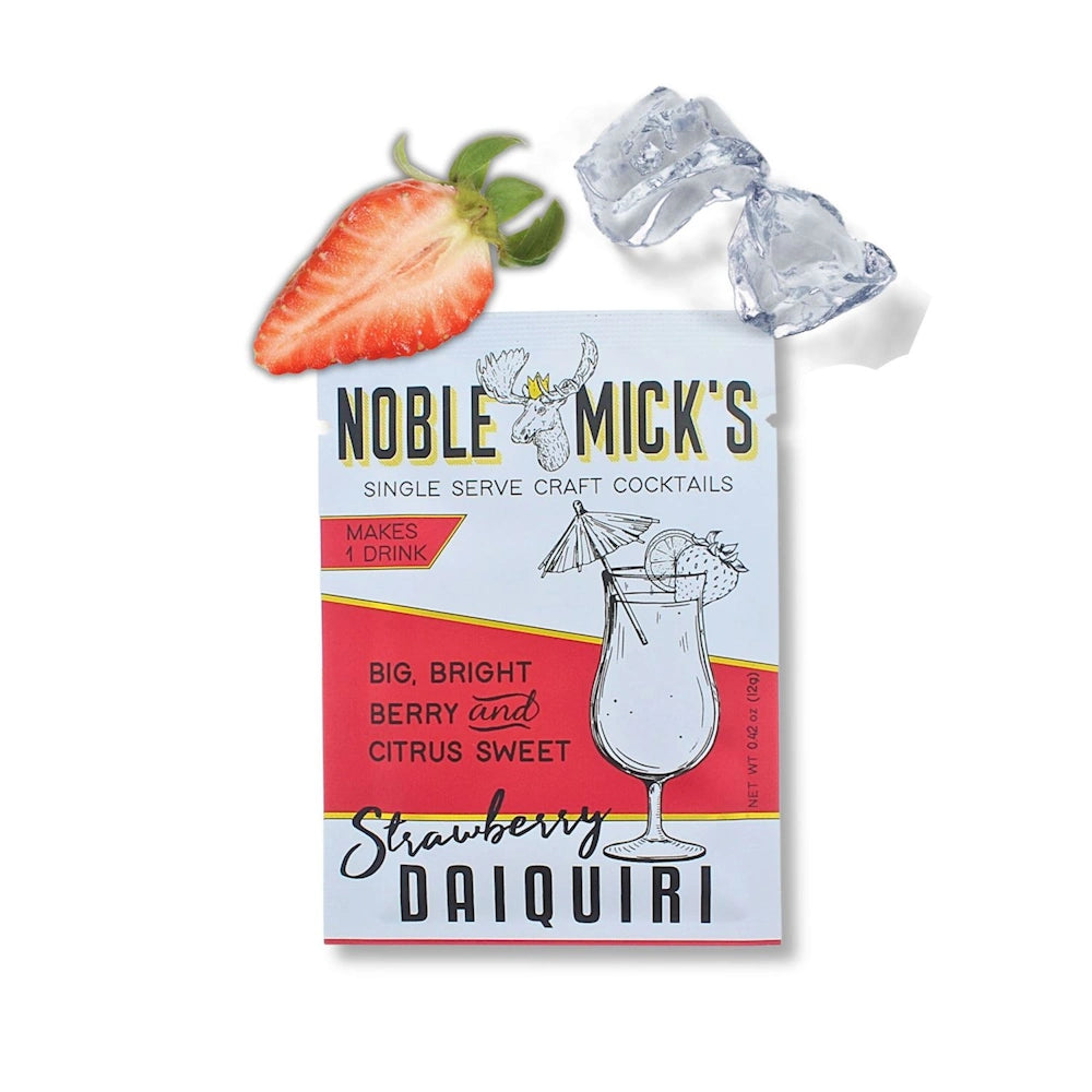 Noble Mick's Strawberry Daiquiri craft cocktail mix packet with a fresh strawberry slice and ice cubes above it.