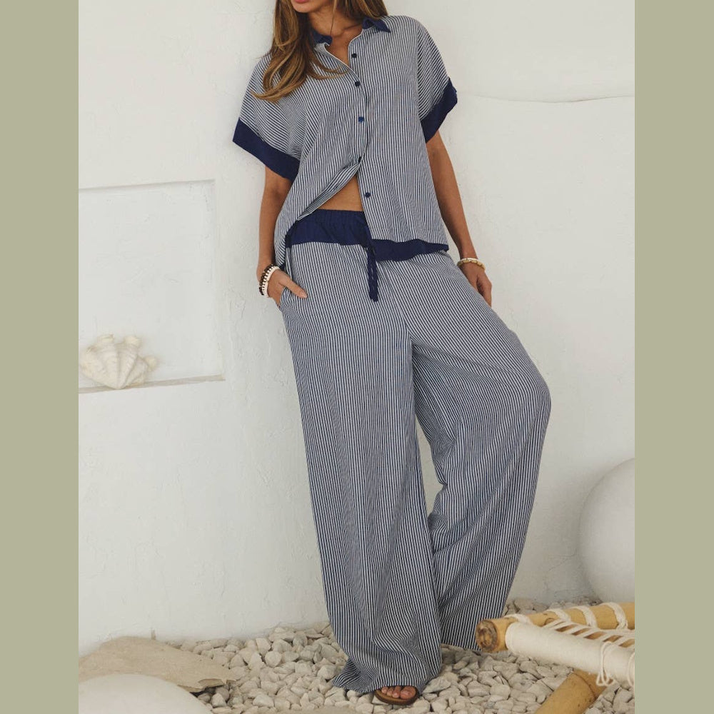 Woman in a striped blue and white short-sleeve button-down shirt and matching wide-leg pants set.