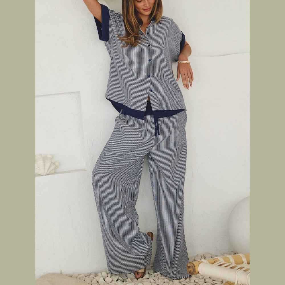 Woman in a blue and white striped button-down short-sleeve shirt and matching wide-leg pants.