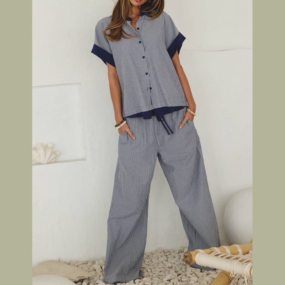 Woman in a striped short-sleeve button-down top and matching wide-leg drawstring pants.